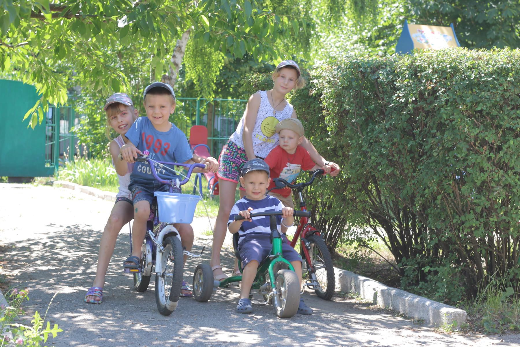 Children riding bicycles outdoors